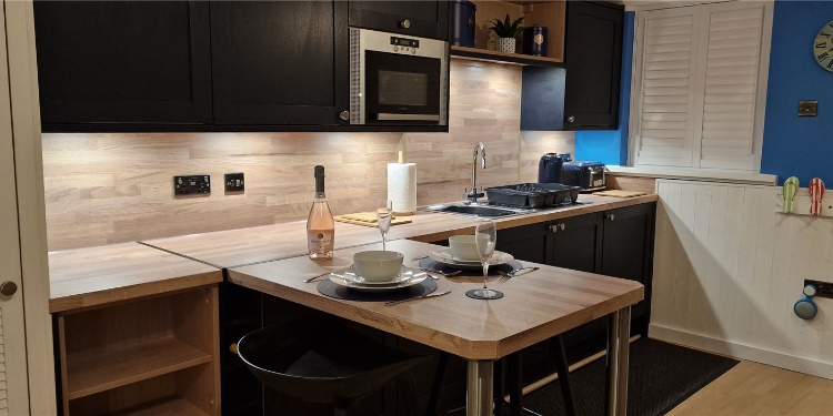 Modern Kitchen with Microwave, Fridge, sink, kettle and toaster