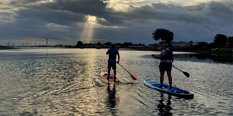 Local Attractions Hayling Island Paddling into the sunrise sunset with a friend